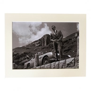 Bond stood over the Cliff from his DB5 Aston A4 Mounted Photo